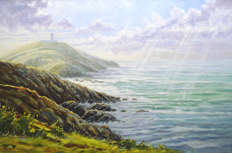 A Welsh art print of Strumble Lighthouse in Pembrokeshire with the wild ocean and the suns rays hitting the headland